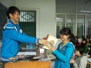 In yet another 1st year class, Tom (our only male, out of 44 girls) presents a gift to his classmate.