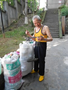 After packaging up everything, Mr. River weighs his items using a traditional Chinese scale.