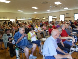 My father (striped blue shirt) and mother sitting beside him put on their poppies.