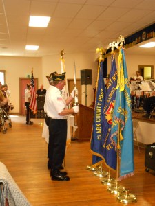 The Color Guard posts the colors (i.e., bring in the US flag and Legion flag)