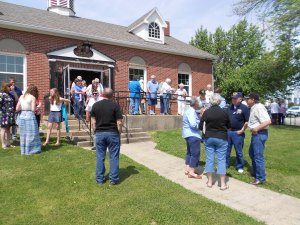 Everyone exits outside where we will have the gun salute.