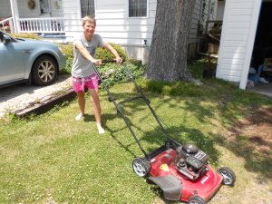The new mower (For my Chinese audience:  Don't mow in bare feet! I'm just posing for the photo.)