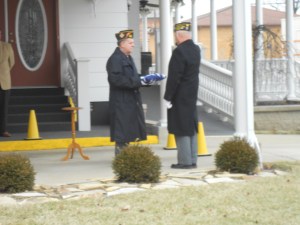 Commander Yeley takes the flag to present to my mom.