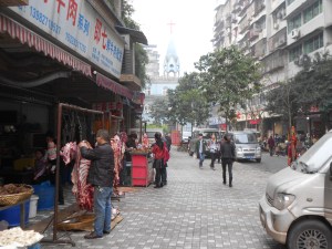 The newly-tiled walkway, leading to the Luzhou Protestant Church, also leads one to fresh hunks of meat. 
