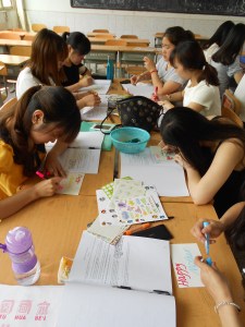 Students busy creating their cards, using decorative stickers to add more color