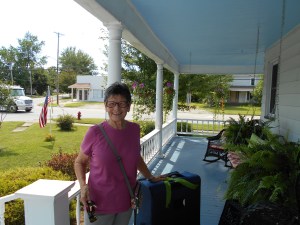 Saying Goodbye: My mom on our front porch with my suitcase