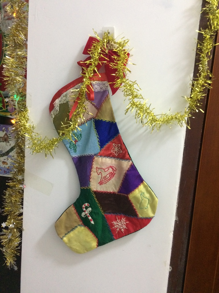 One of my overseas Christmas Stockings decorated my apartment wall in China.